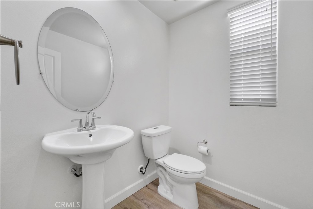 180 Heartwood Way Anaheim, CA 92801 - Photo 18 of 38 a bathroom with a sink a toilet and mirror