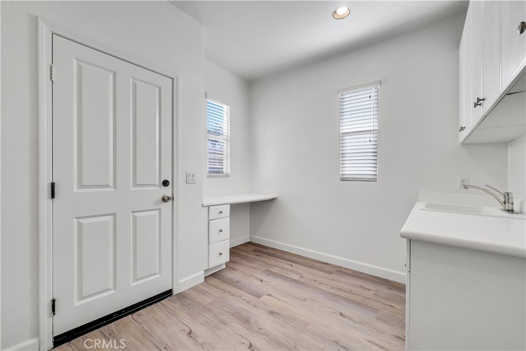 180 Heartwood Way Anaheim, CA 92801 - Photo 19 of 38 a view of an empty room with a window and wooden floor