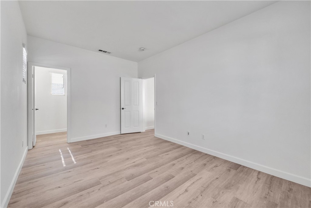 180 Heartwood Way Anaheim, CA 92801 - Photo 24 of 38 a view of an empty room and wooden floor