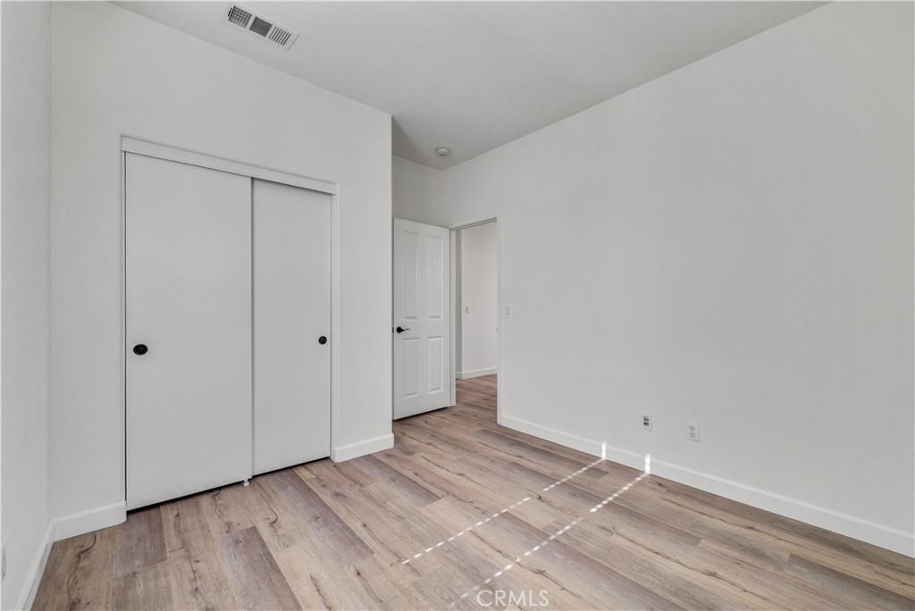 180 Heartwood Way Anaheim, CA 92801 - Photo 26 of 38 a view of an empty room and wooden floor