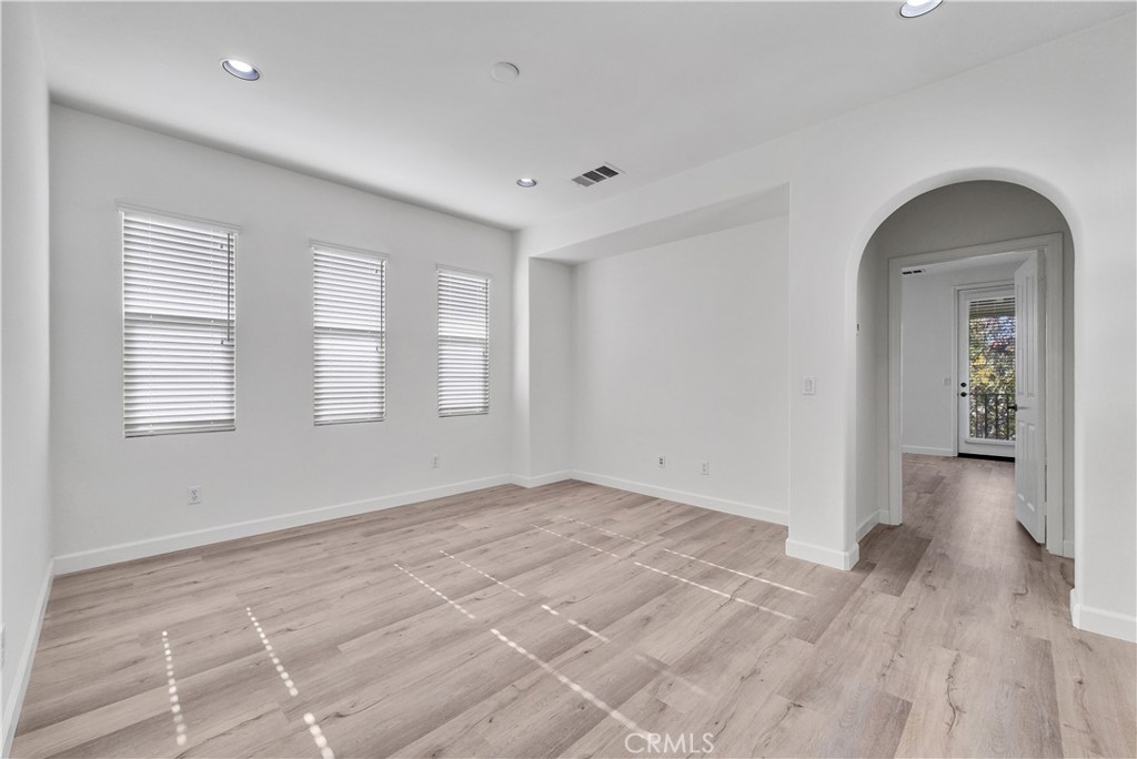 180 Heartwood Way Anaheim, CA 92801 - Photo 28 of 38 a view of empty room with wooden floor and fan