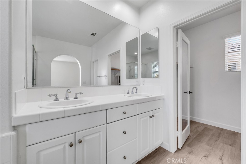 180 Heartwood Way Anaheim, CA 92801 - Photo 33 of 38 a bathroom with a double vanity sink and mirror