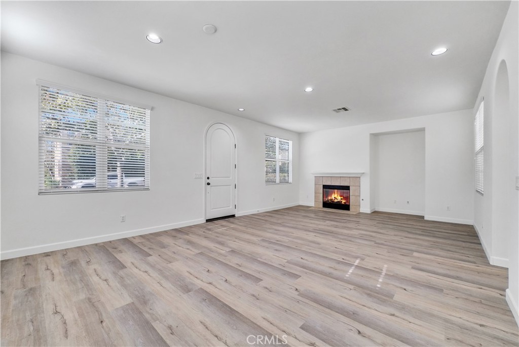 180 Heartwood Way Anaheim, CA 92801 - Photo 6 of 38 a view of empty room with wooden floor and fireplace