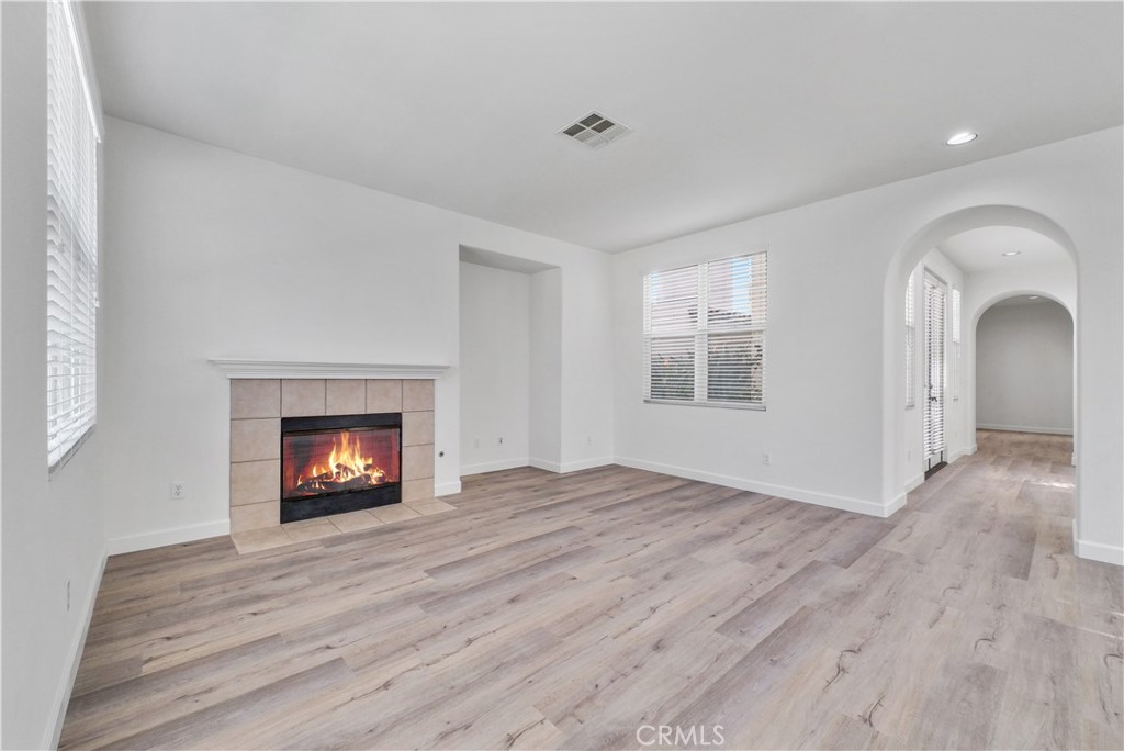 180 Heartwood Way Anaheim, CA 92801 - Photo 8 of 38 a view of an empty room with a window and fireplace