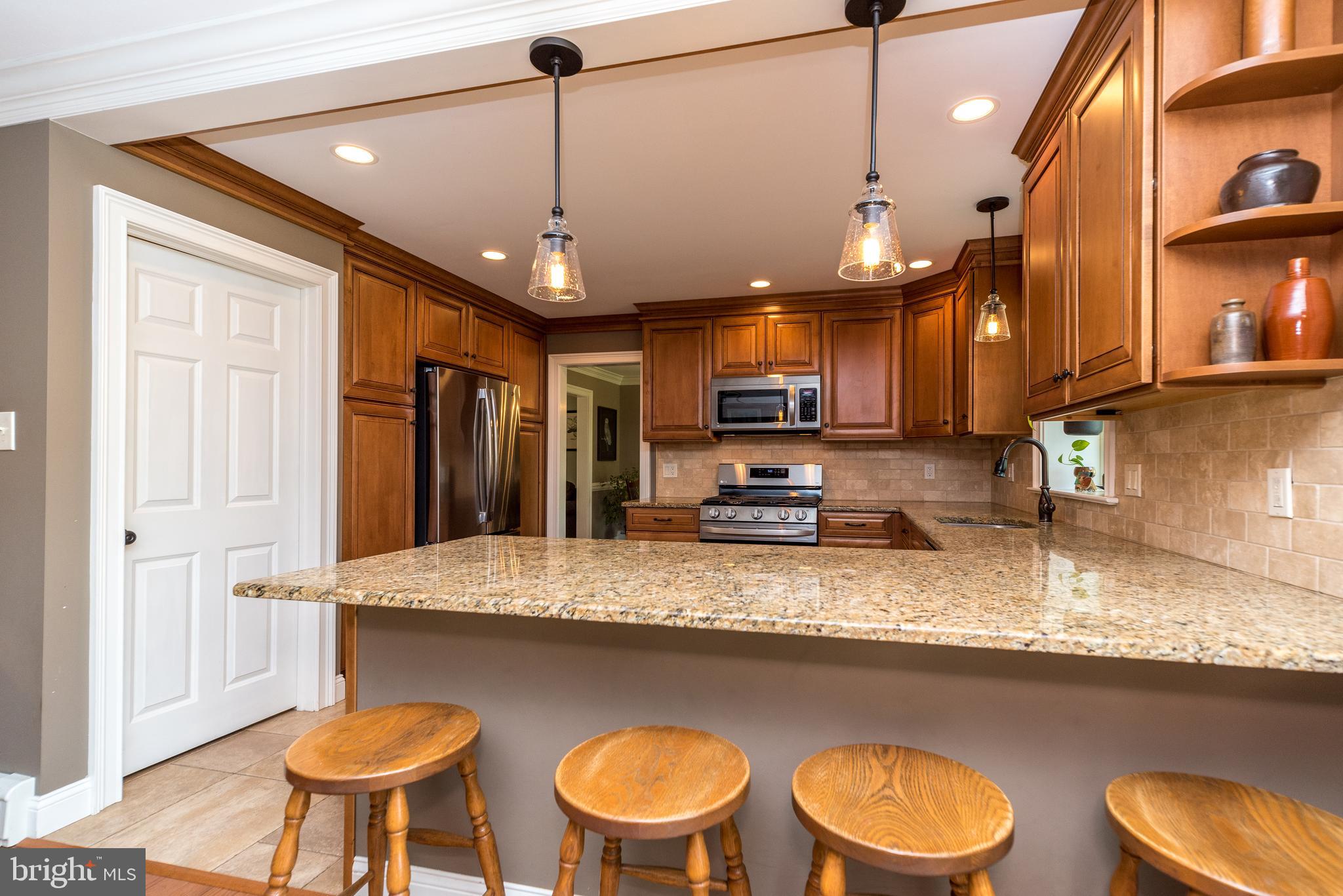 43 Clemens Road Doylestown, PA 18901 - Photo 13 of 34 a kitchen with stainless steel appliances granite countertop a sink a stove and a microwave