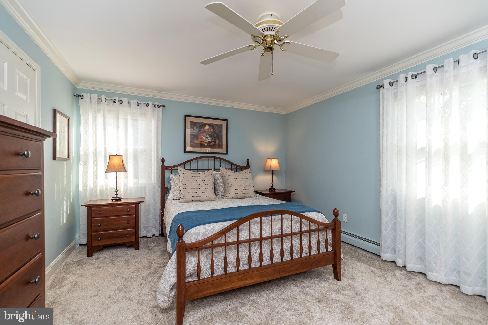 43 Clemens Road Doylestown, PA 18901 - Photo 21 of 34 a bedroom with a bed and a chandelier