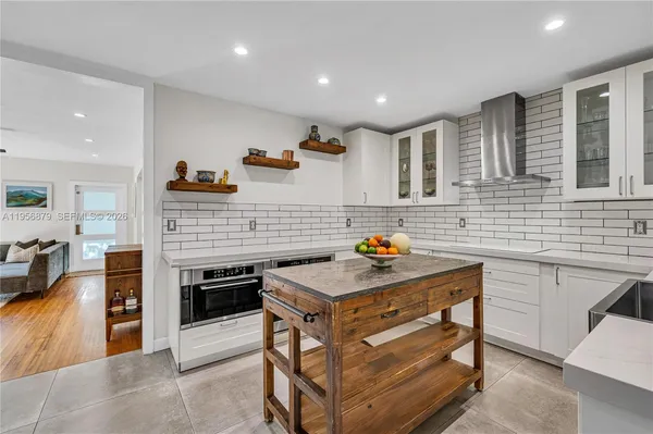 a kitchen that has a sink and a stove