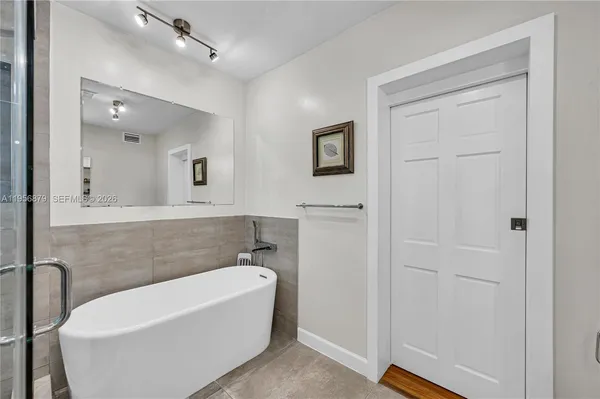 a bathroom with a bathtub and a shower