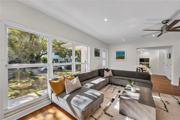 a living room with furniture and a large window