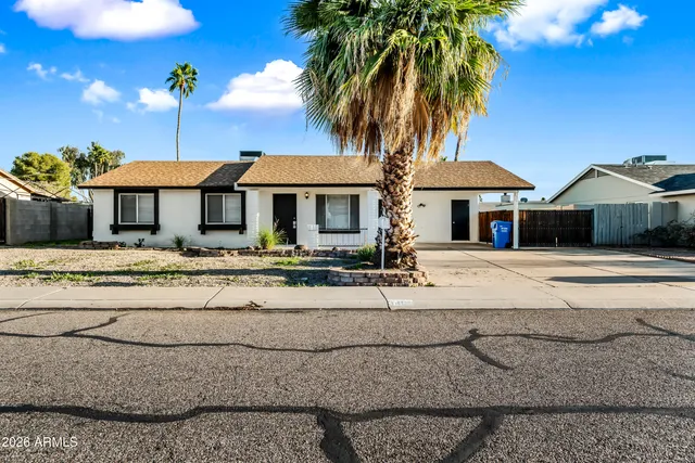 a front view of a house with a garden and patio