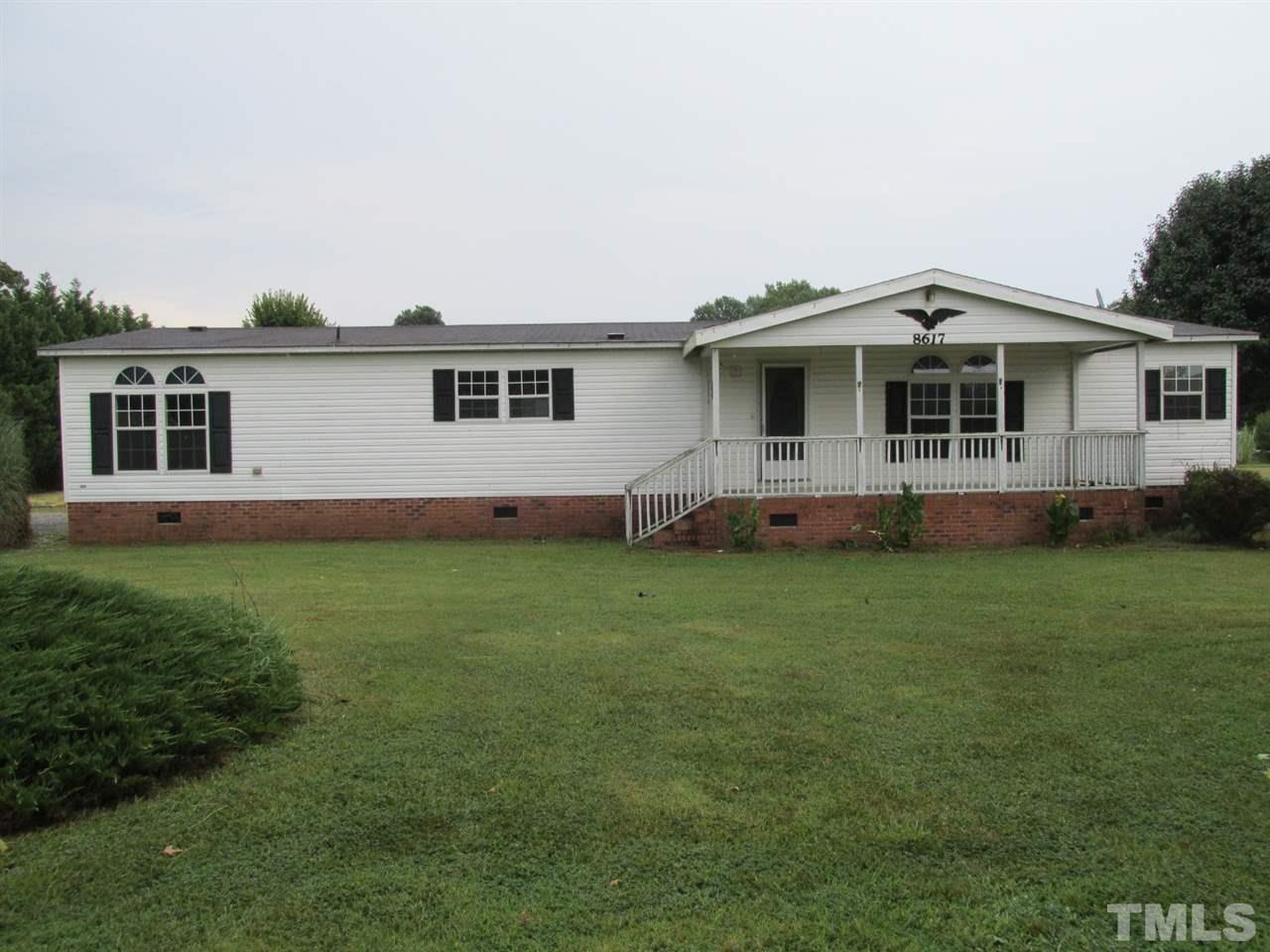 8617 Walter Myatt Road Willow Spring, NC 27592 - Photo 1 of 22 a front view of house with yard and green space