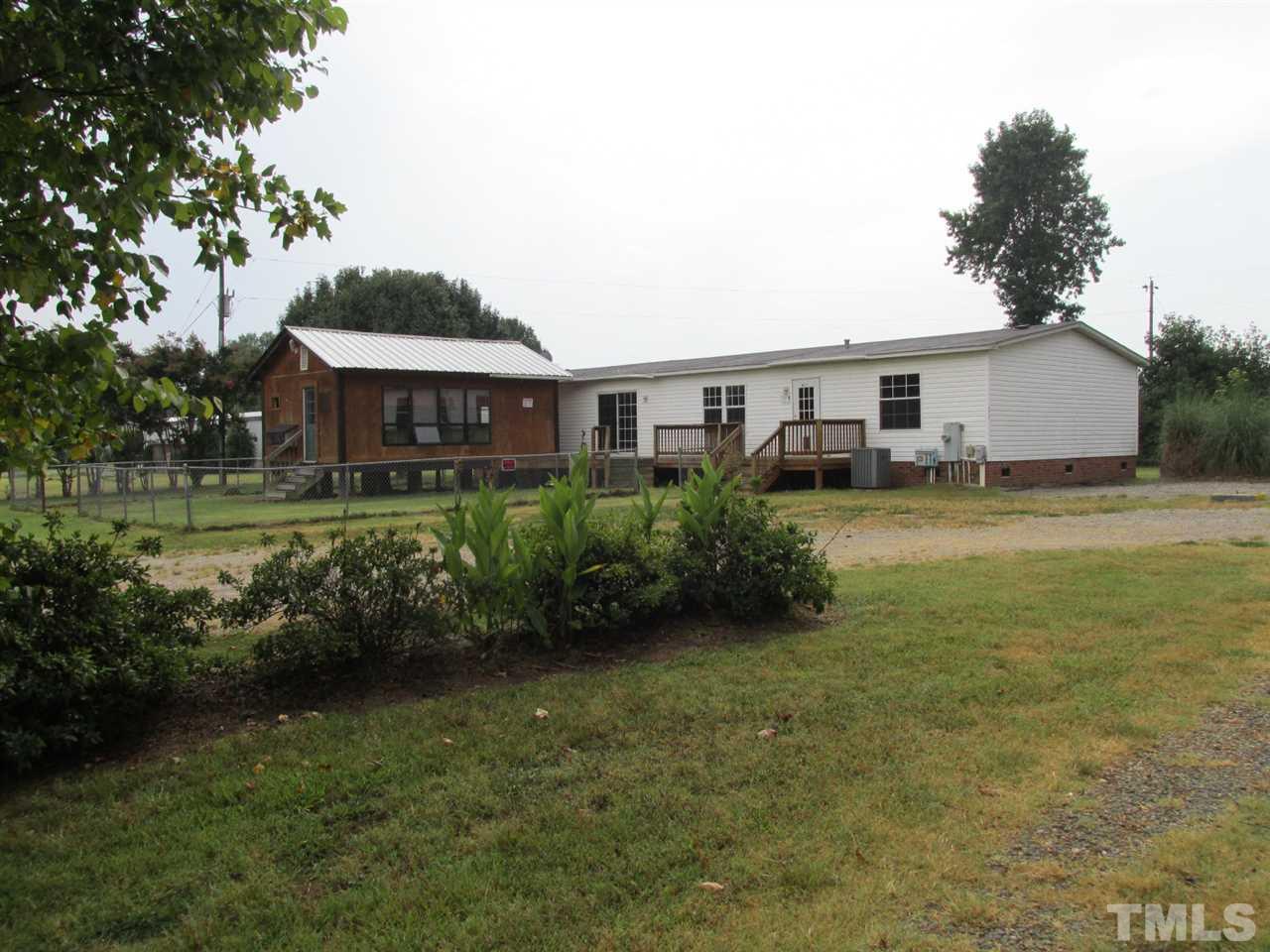 8617 Walter Myatt Road Willow Spring, NC 27592 - Photo 2 of 22 a view of a house with garden and a yard