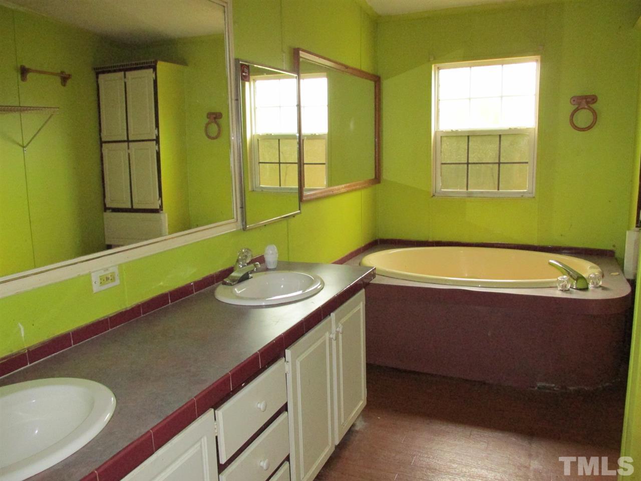 8617 Walter Myatt Road Willow Spring, NC 27592 - Photo 16 of 22 a bathroom with a sink and a bathtub