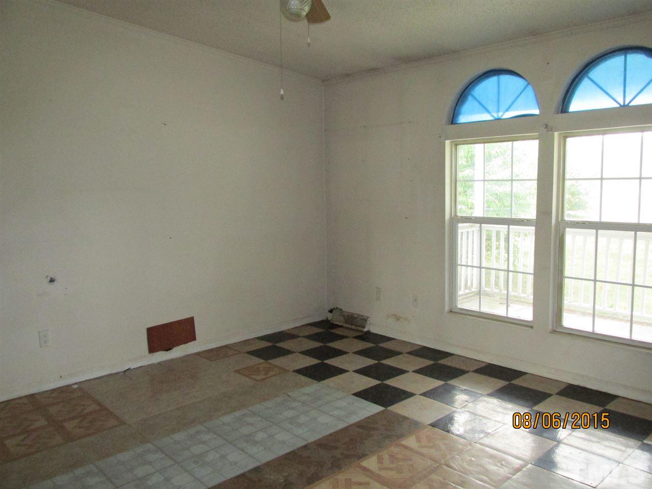 8617 Walter Myatt Road Willow Spring, NC 27592 - Photo 17 of 22 a view of a livingroom with wooden floor and a window