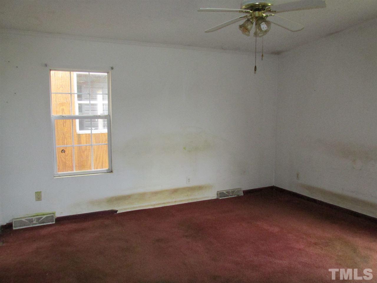 8617 Walter Myatt Road Willow Spring, NC 27592 - Photo 18 of 22 an empty room with a window
