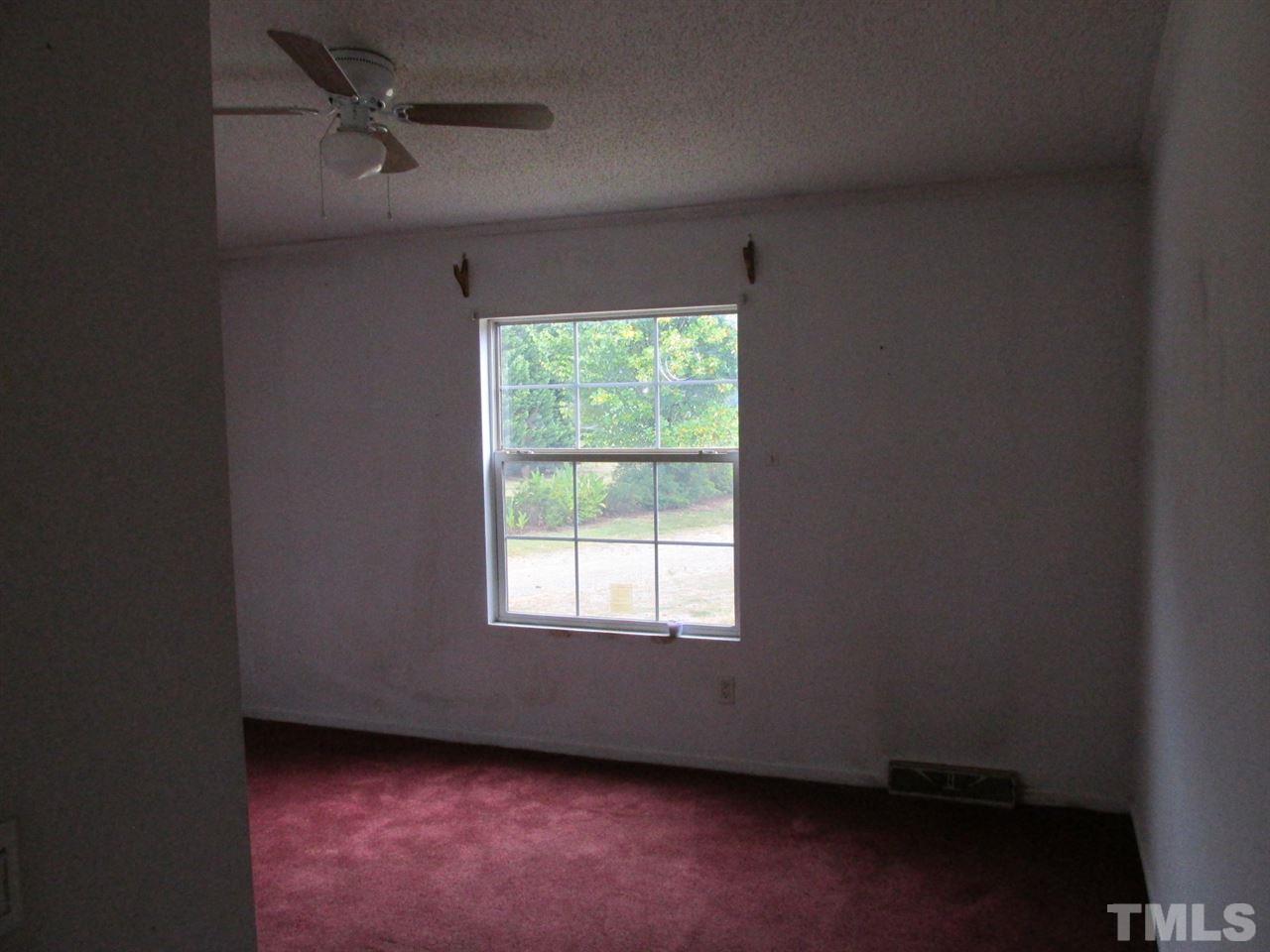8617 Walter Myatt Road Willow Spring, NC 27592 - Photo 20 of 22 an empty room with a window