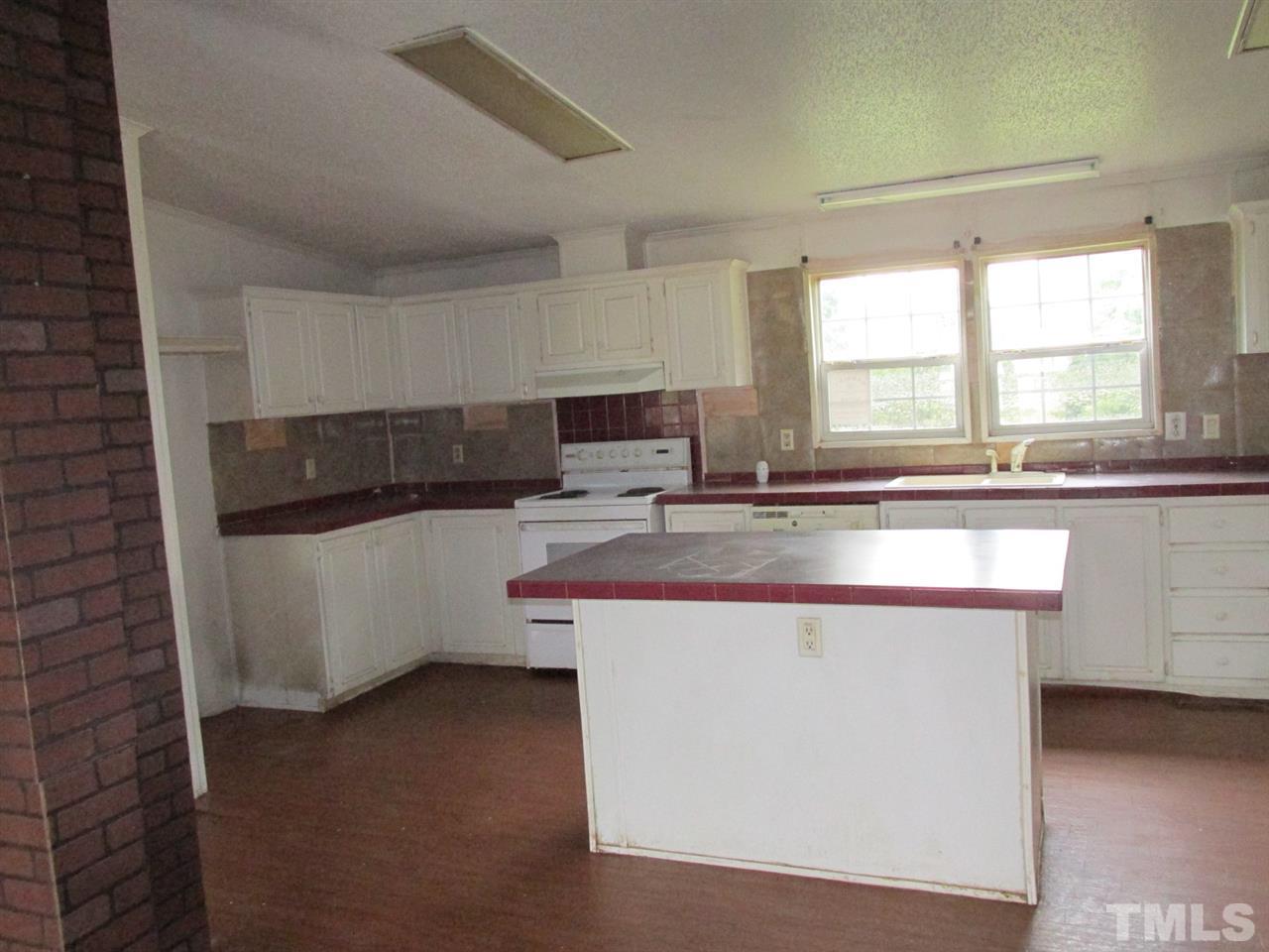 8617 Walter Myatt Road Willow Spring, NC 27592 - Photo 22 of 22 a kitchen with stainless steel appliances a sink and a stove