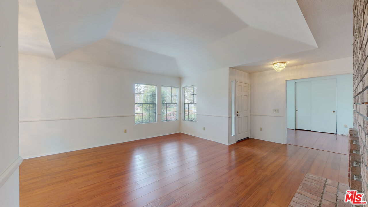 17 Firestone Irvine, CA 92614 - Photo 11 of 75 an empty room with wooden floor and windows