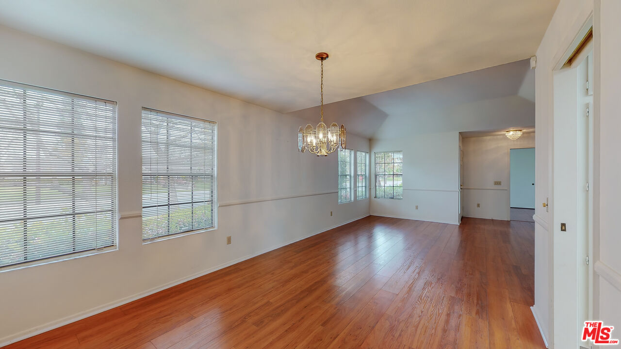 17 Firestone Irvine, CA 92614 - Photo 12 of 75 a view of an empty room with wooden floor and a window