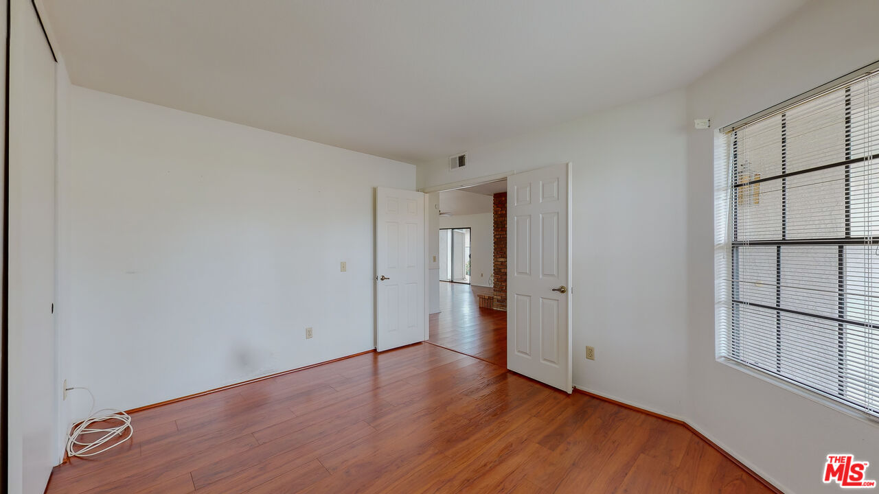 17 Firestone Irvine, CA 92614 - Photo 17 of 75 a view of an empty room with wooden floor and a window