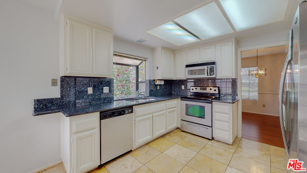 17 Firestone Irvine, CA 92614 - Photo 26 of 75 a kitchen with stainless steel appliances granite countertop a stove a sink and a refrigerator