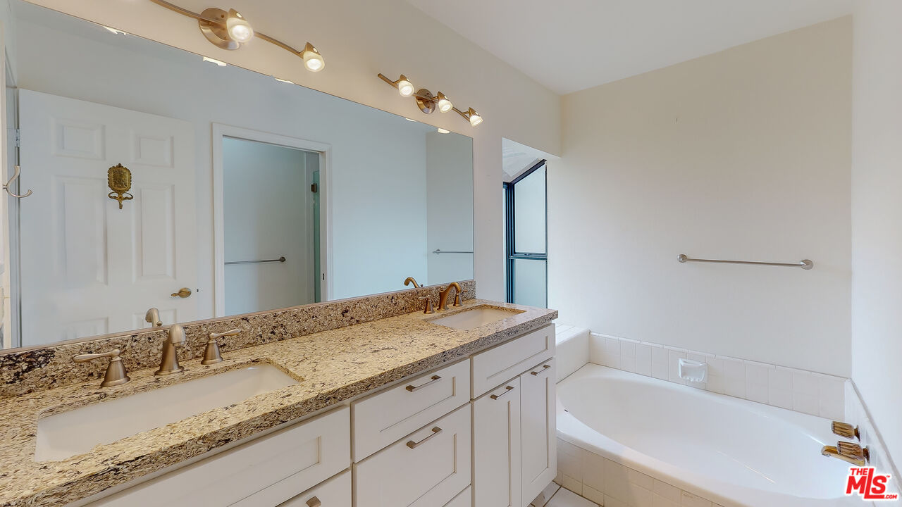 17 Firestone Irvine, CA 92614 - Photo 32 of 75 a bathroom with a granite countertop sink double vanity granite and a bathtub