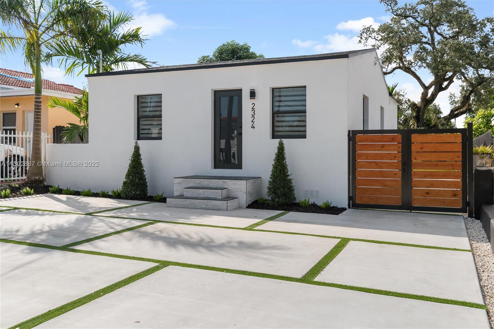2324 Southwest 58th Court Miami, FL 33155 - Photo 1 of 25 a front view of a house with garage