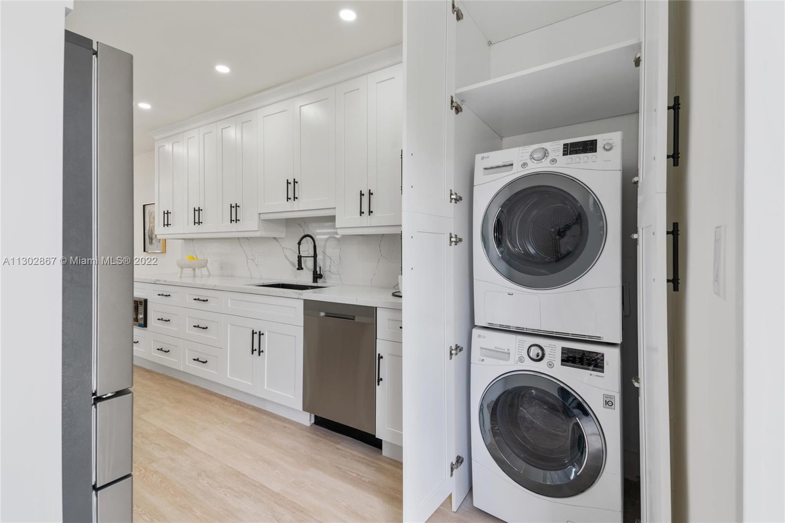 2324 Southwest 58th Court Miami, FL 33155 - Photo 11 of 25 a view of a kitchen with a sink a washer and dryer