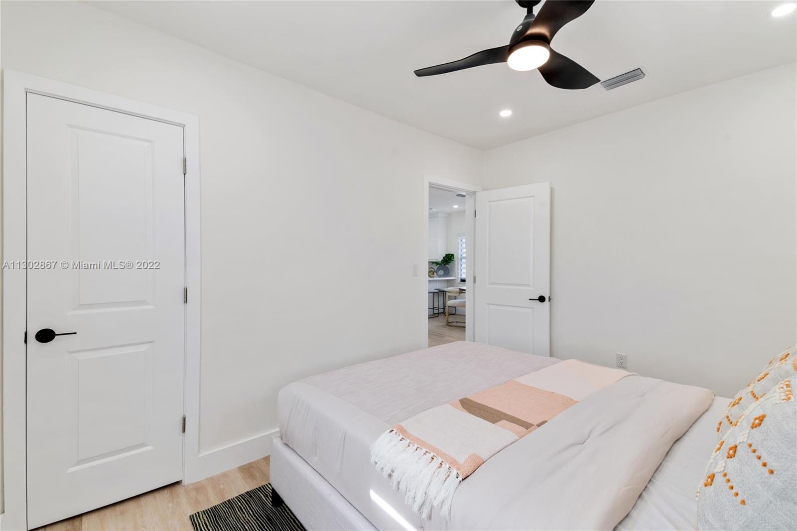 2324 Southwest 58th Court Miami, FL 33155 - Photo 13 of 25 a bedroom with a bed and a chandelier