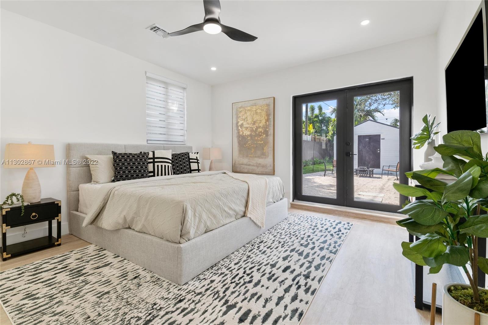 2324 Southwest 58th Court Miami, FL 33155 - Photo 17 of 25 a bedroom with a large bed and a potted plant
