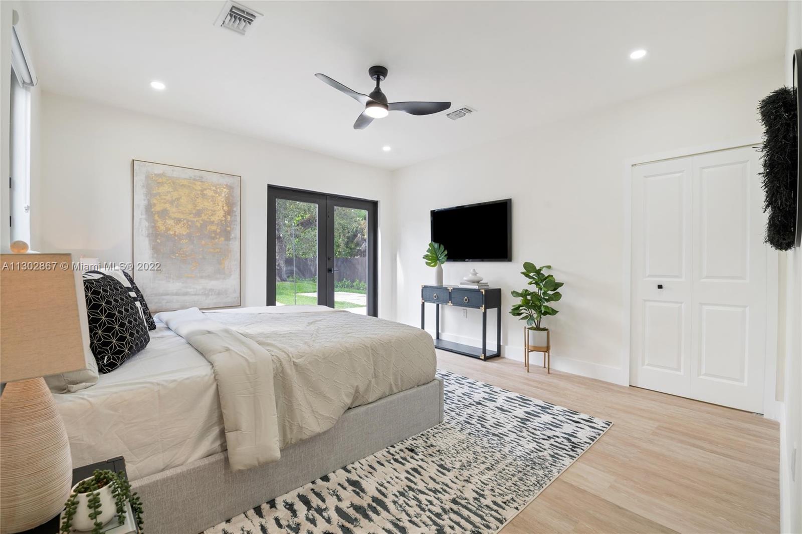 2324 Southwest 58th Court Miami, FL 33155 - Photo 18 of 25 a bedroom with a bed and a flat screen tv