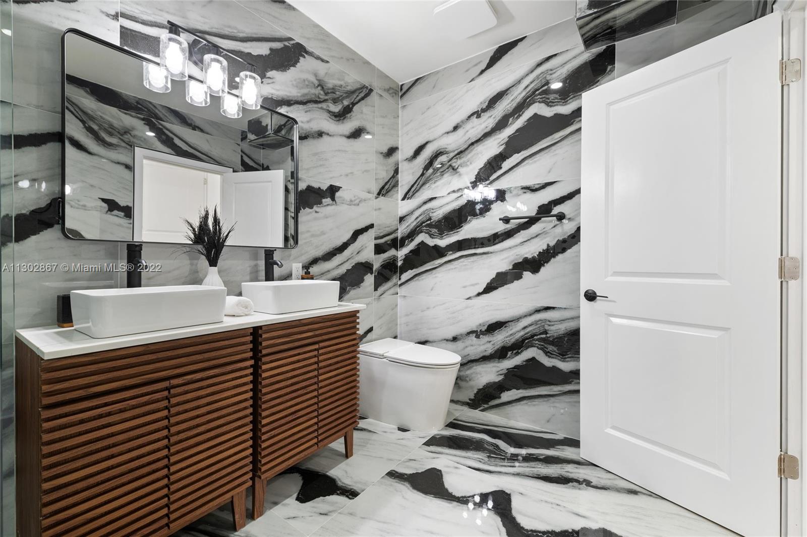 2324 Southwest 58th Court Miami, FL 33155 - Photo 19 of 25 a bathroom with a sink and mirror