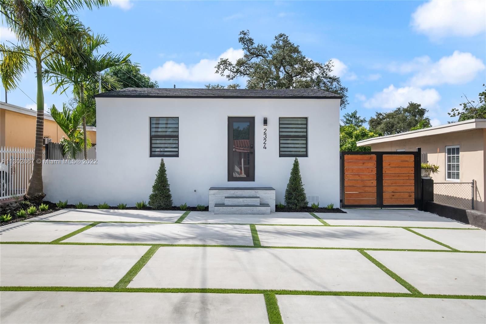 2324 Southwest 58th Court Miami, FL 33155 - Photo 2 of 25 a front view of a house with a garden