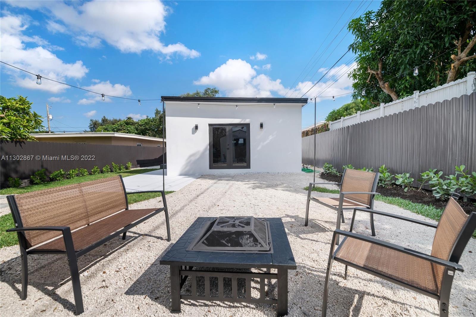 2324 Southwest 58th Court Miami, FL 33155 - Photo 21 of 25 a front view of a house with garden and sitting area