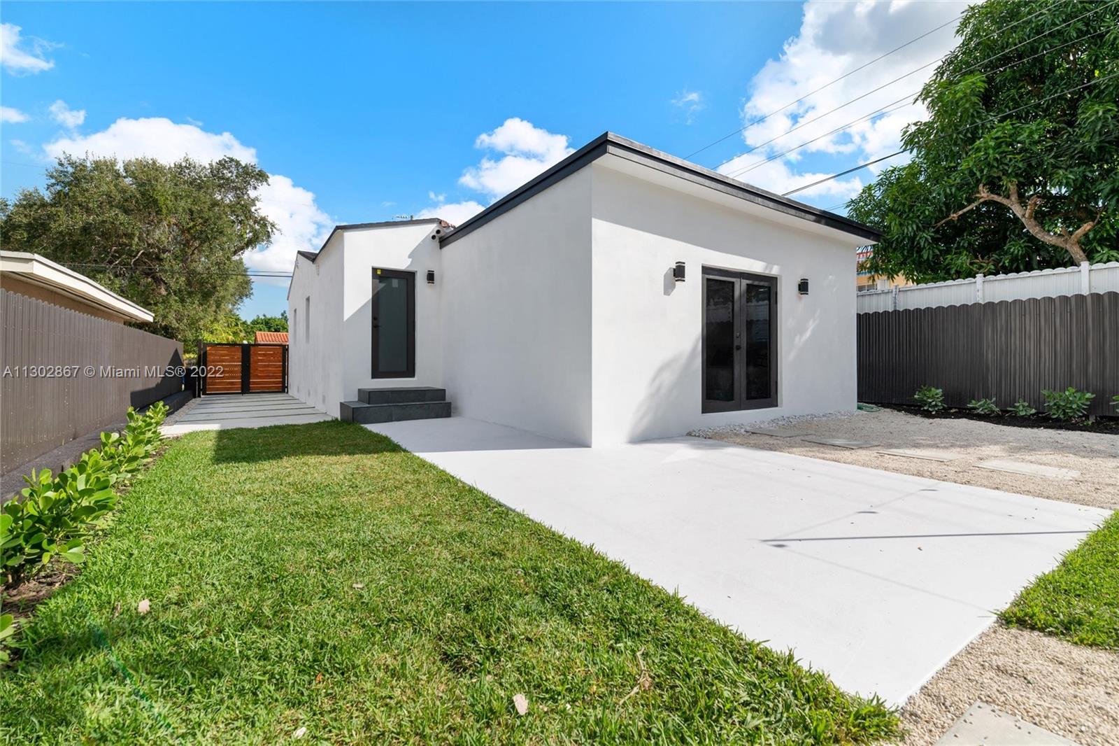 2324 Southwest 58th Court Miami, FL 33155 - Photo 22 of 25 a front view of a house with garden