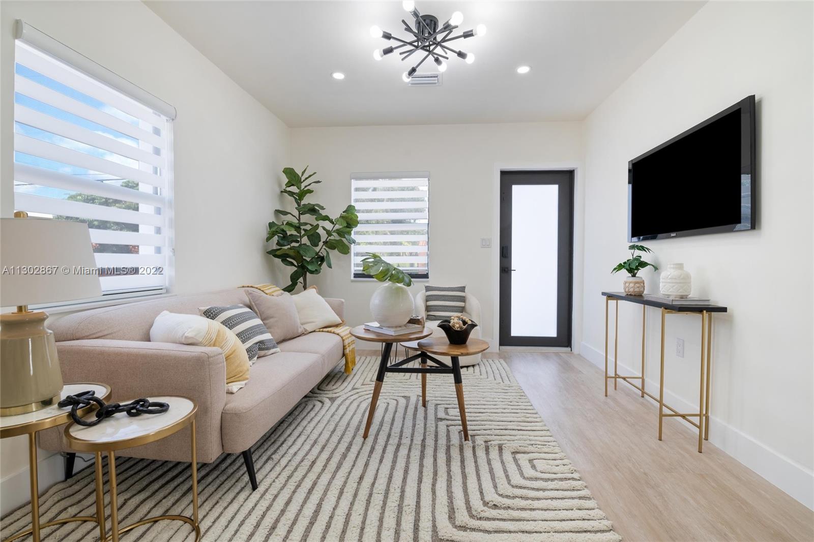 2324 Southwest 58th Court Miami, FL 33155 - Photo 6 of 25 a living room with furniture and a flat screen tv