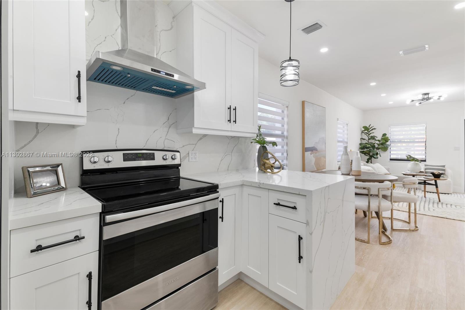 2324 Southwest 58th Court Miami, FL 33155 - Photo 9 of 25 a kitchen with a stove and white cabinets