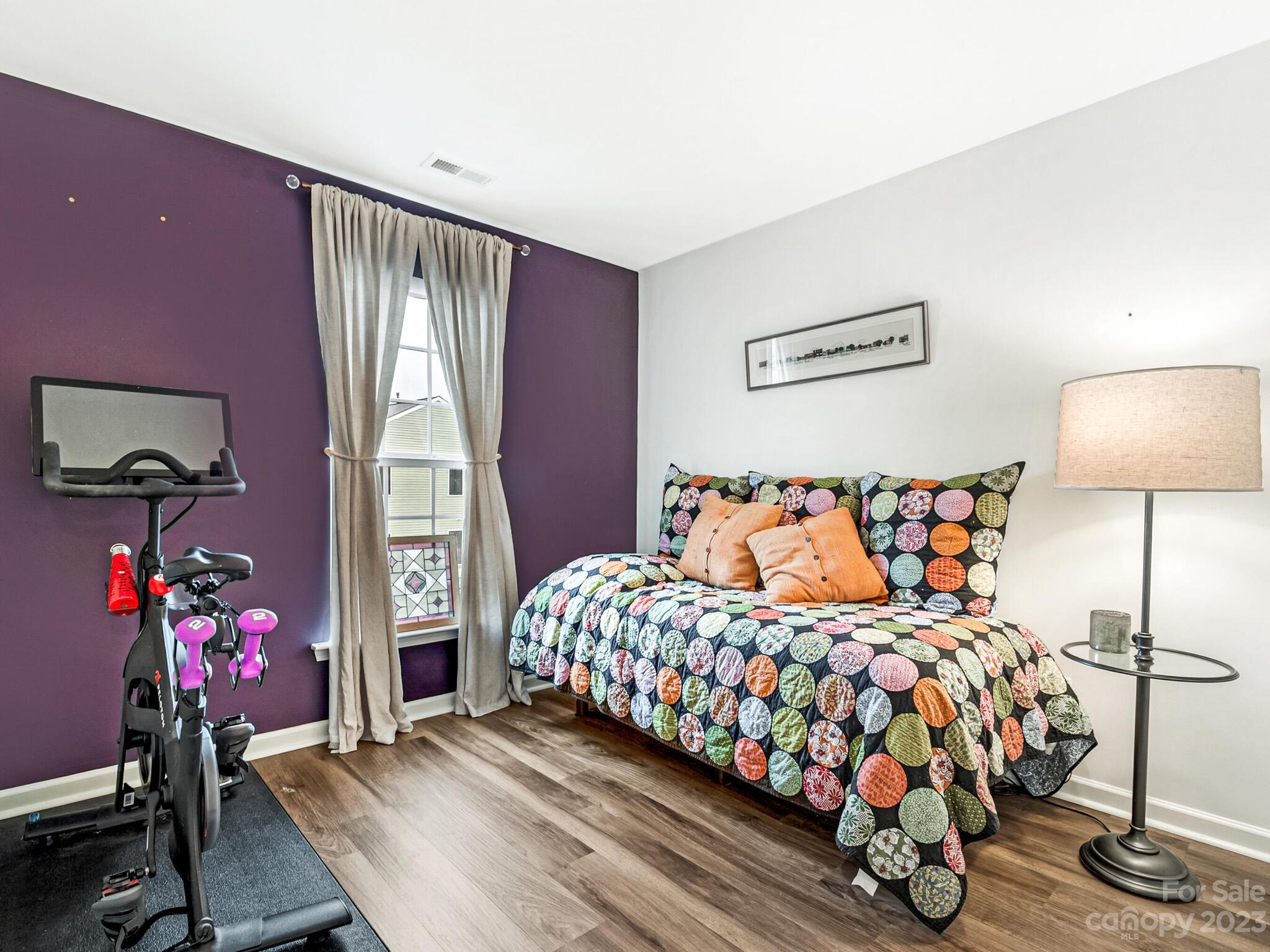 907 Wicawa Road Fort Mill, SC 29708 - Photo 21 of 25 a bedroom with a bed and wooden floor