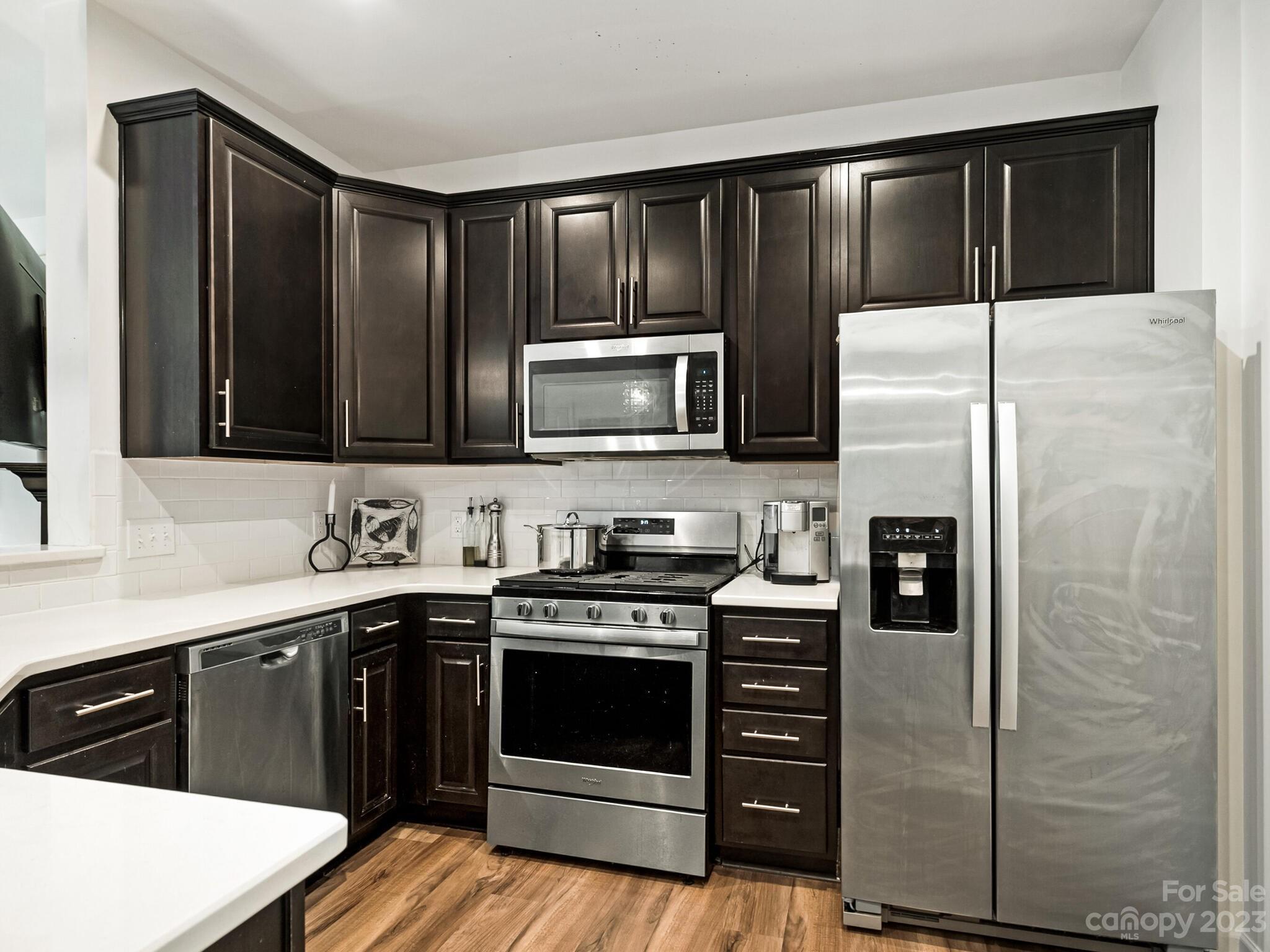 907 Wicawa Road Fort Mill, SC 29708 - Photo 6 of 25 a kitchen with stainless steel appliances granite countertop a stove a refrigerator and a sink