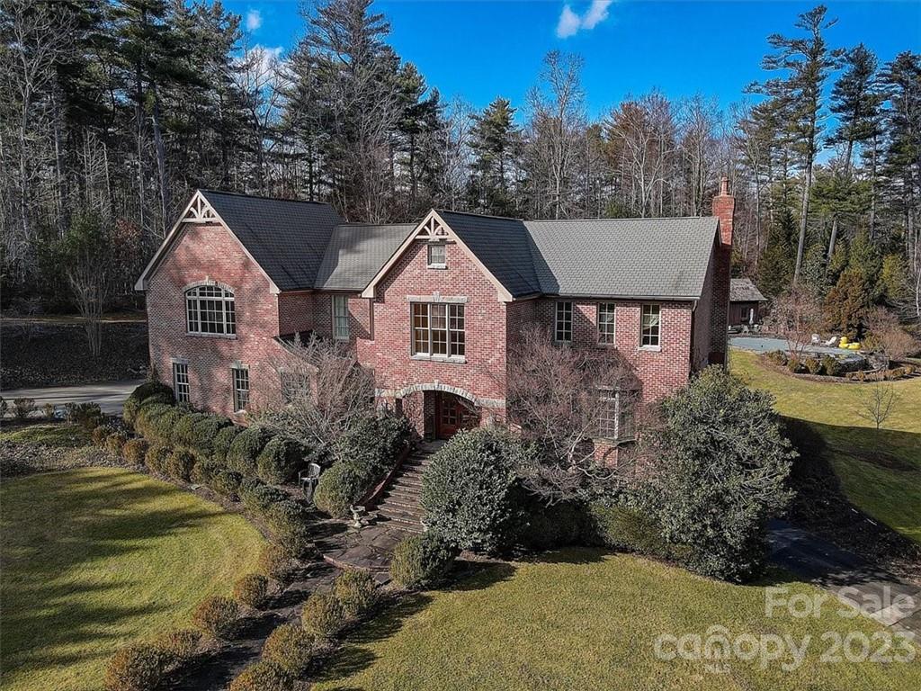 a aerial view of a house with a yard and lake view