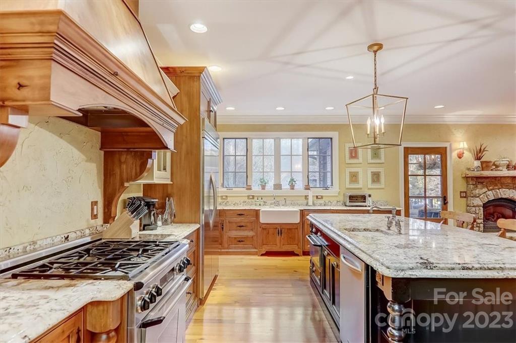 99 Mullally Drive Flat Rock, NC 28731 - Photo 15 of 48 a kitchen with stainless steel appliances granite countertop a sink stove and cabinets