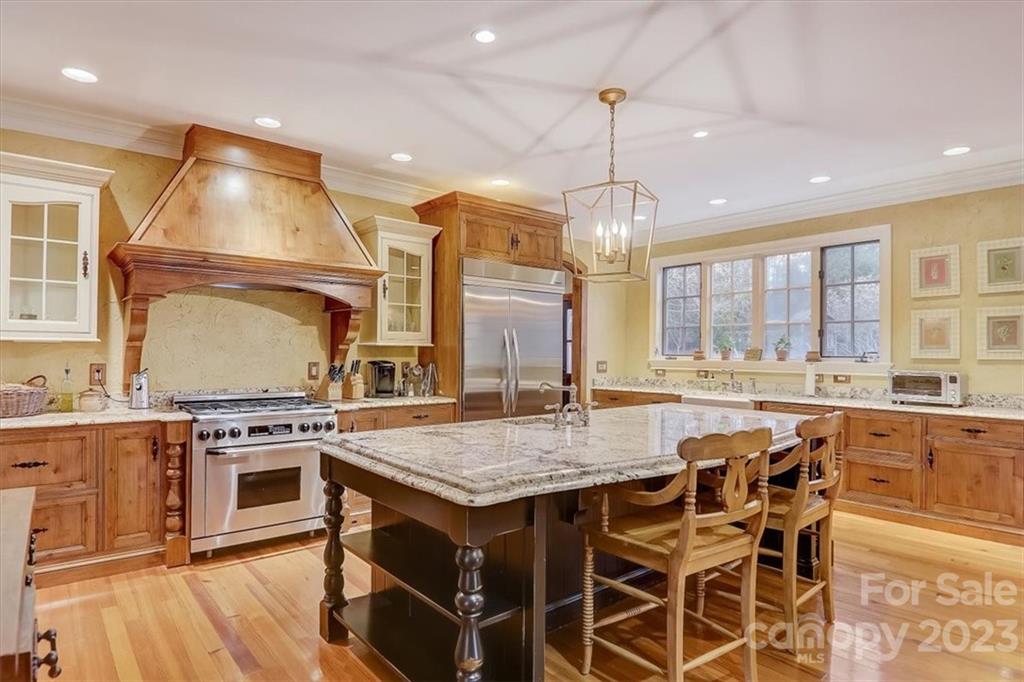 99 Mullally Drive Flat Rock, NC 28731 - Photo 17 of 48 a kitchen with stainless steel appliances granite countertop a stove and more cabinets
