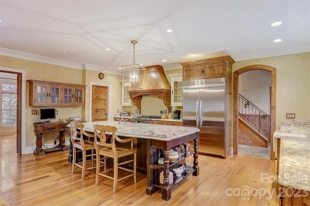 99 Mullally Drive Flat Rock, NC 28731 - Photo 18 of 48 a kitchen with stainless steel appliances kitchen island granite countertop a table and chairs in it