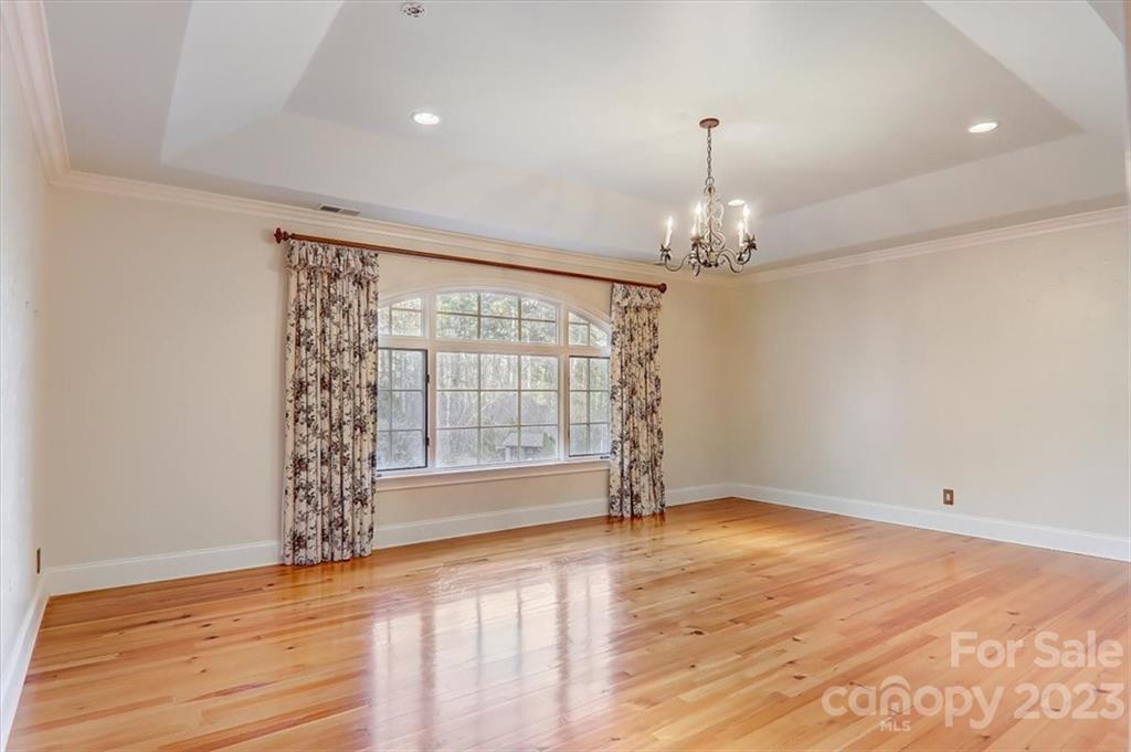 99 Mullally Drive Flat Rock, NC 28731 - Photo 25 of 48 an empty room with wooden floor and windows