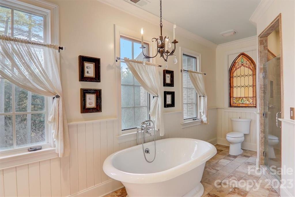99 Mullally Drive Flat Rock, NC 28731 - Photo 29 of 48 a spacious bathroom with a sink a toilet and a mirror