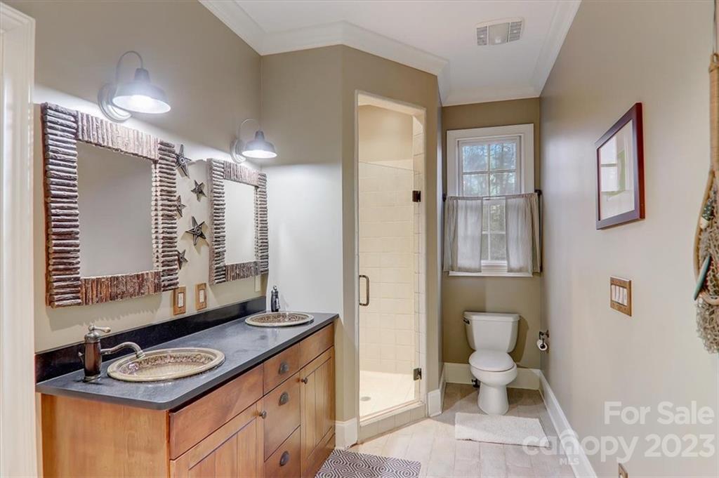 99 Mullally Drive Flat Rock, NC 28731 - Photo 33 of 48 a bathroom with a granite countertop sink toilet and shower