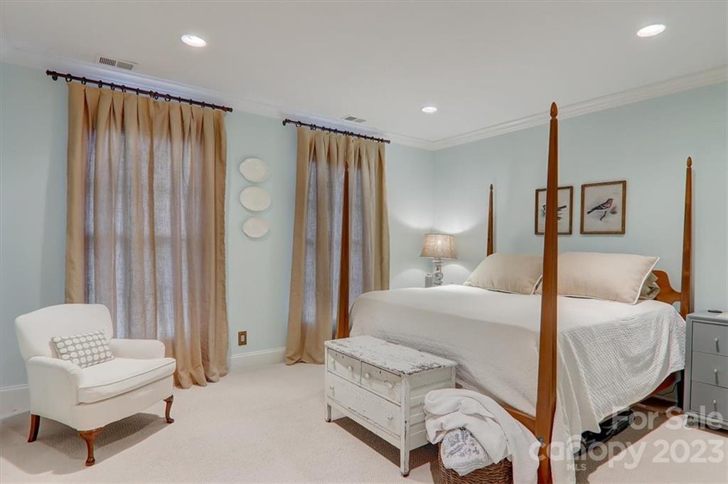 99 Mullally Drive Flat Rock, NC 28731 - Photo 35 of 48 a bedroom with a bed and a chandelier