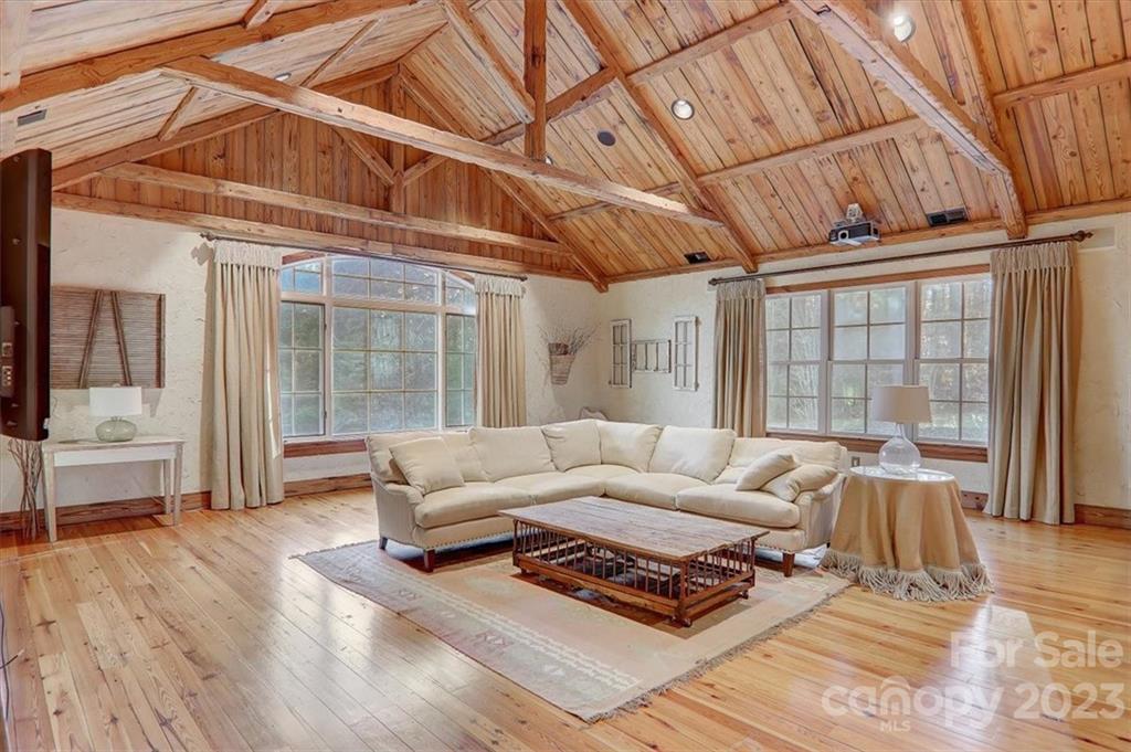 99 Mullally Drive Flat Rock, NC 28731 - Photo 37 of 48 a living room with furniture a wooden floor and a large window