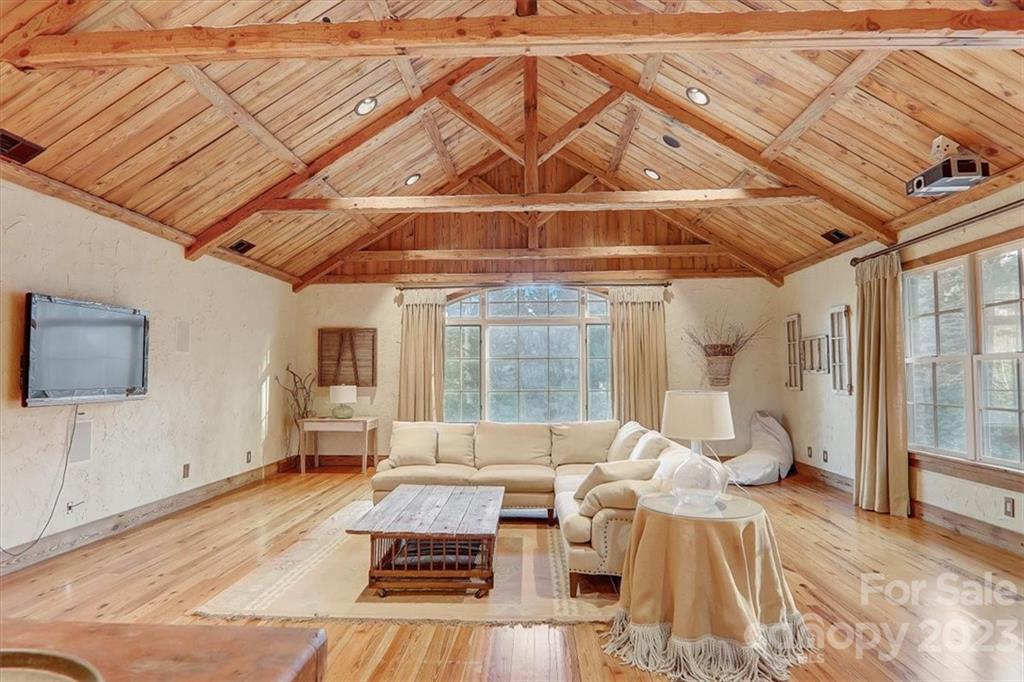 99 Mullally Drive Flat Rock, NC 28731 - Photo 38 of 48 a living room with furniture and a flat screen tv