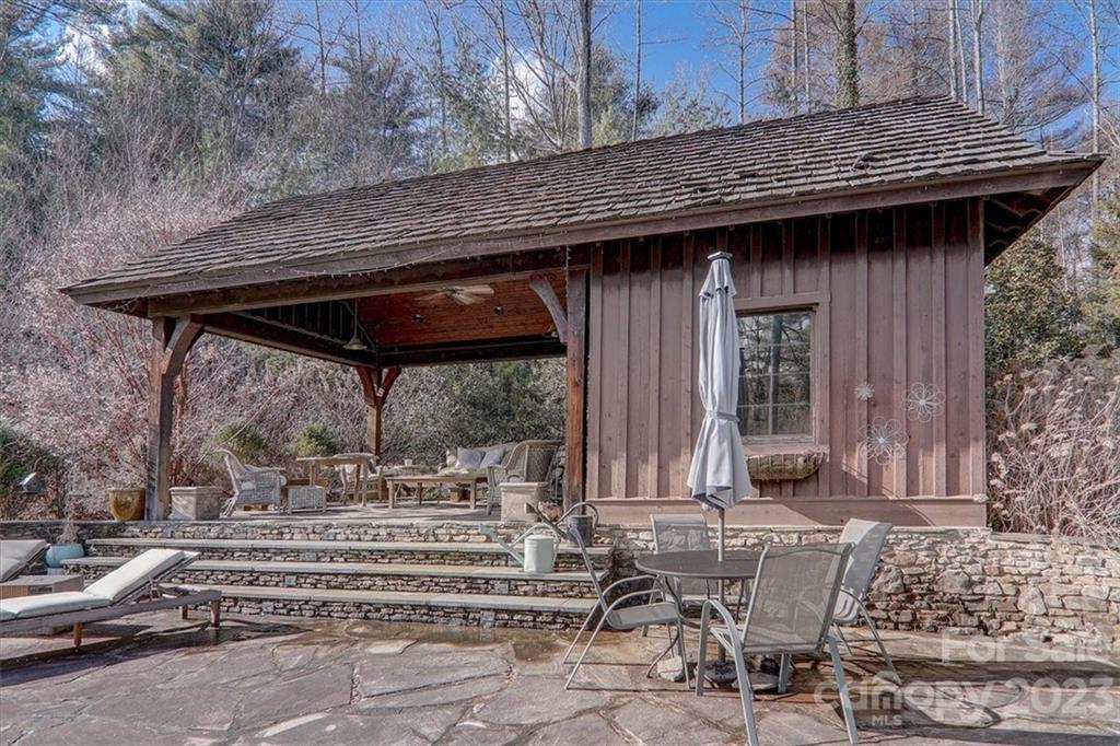 99 Mullally Drive Flat Rock, NC 28731 - Photo 41 of 48 a view of a patio with table and chairs with wooden floor and fence